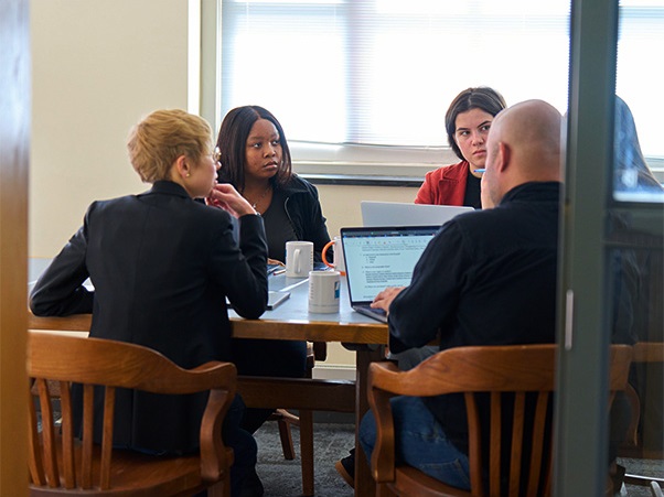 Catherine Herrold, Thuba Nkiwane, Sophie Clinton, Tina Nabatchi and Jonathan Garcia working in conference room at PARCC